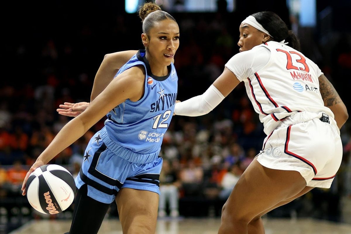 Jun 2, 2026; Washington, District of Columbia, USA; Chicago Sky guard Sydney Taylor (12) drives past Washington Mystics guard Cotie McMahon (23) during the first half at CareFirst Arena. Mandatory Credit: Daniel Kucin Jr.-Imagn Images