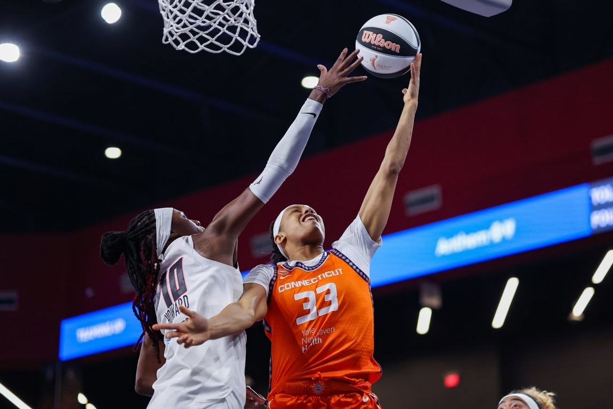 Jun 2, 2026; College Park, Georgia, USA; Connecticut Sun forward Nell Angloma (33) shoots past Atlanta Dream guard Rhyne Howard (10) in the third quarter at Gateway Center Arena at College Park. Mandatory Credit: Brett Davis-Imagn Images