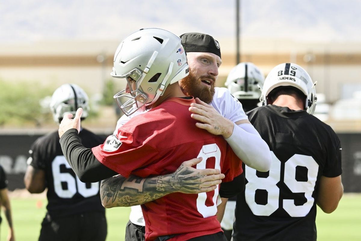 Jun 3, 2026; Henderson, NV, USA; Las Vegas Raiders defensive end Maxx Crosby (98) hugs quarterback Kirk Cousins (8) during organized team activities at Intermountain Health Performance Center. Mandatory Credit: Candice Ward-Imagn Images