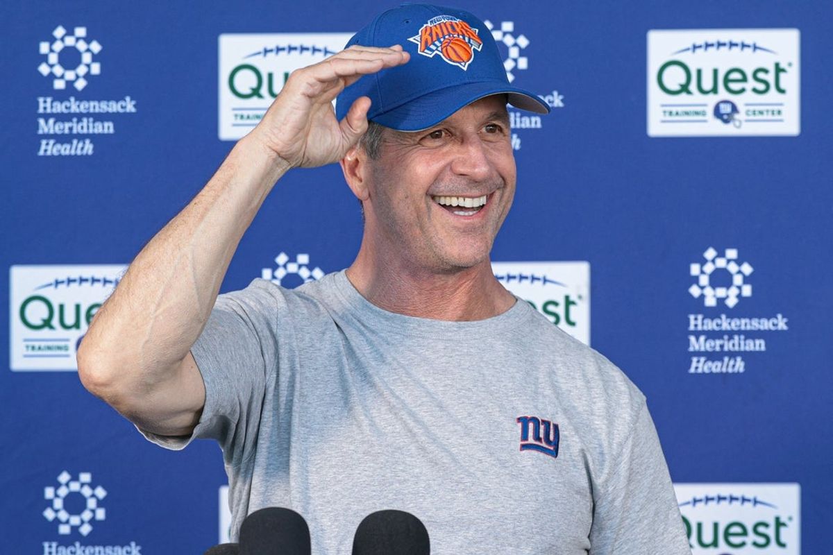 Jun 3, 2026; East Rutherford, NJ, USA; New York Giants head coach John Harbaugh show support of the New York Knicks before speaking with media after organized team activities at Quest Diagnostics Training Center. Mandatory Credit: Vincent Carchietta-Imagn Images