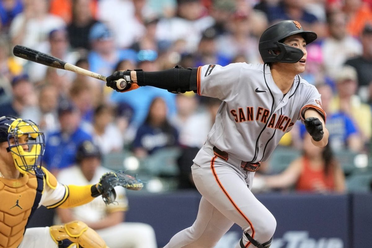 Jun 3, 2026; Milwaukee, Wisconsin, USA;  San Francisco Giants center fielder Jung Hoo Lee (51) singles during the fourth inning against the Milwaukee Brewers at American Family Field. Mandatory Credit: Jeff Hanisch-Imagn Images