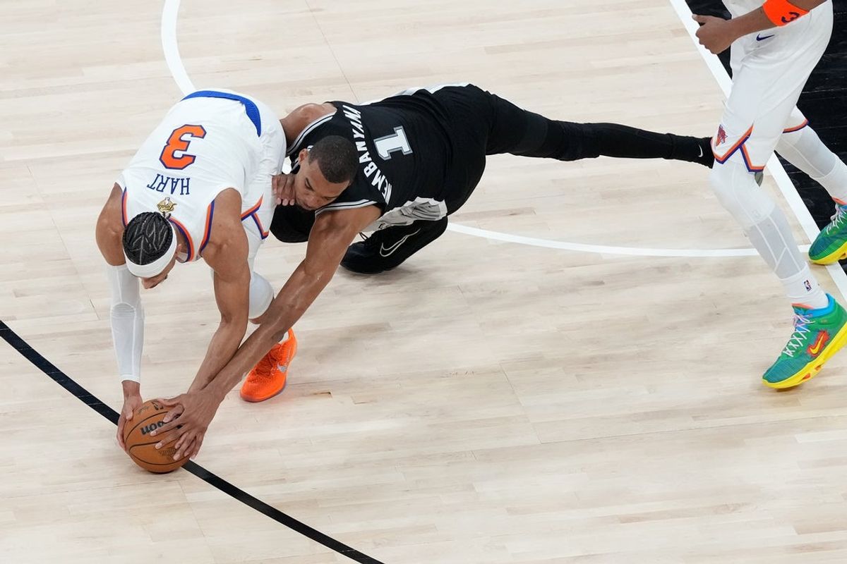 Jun 3, 2026; San Antonio, Texas, USA; San Antonio Spurs forward Victor Wembanyama (1) attempts to steal the ball from New York Knicks guard Josh Hart (3) in the second half during game one of the 2026 NBA Finals at Frost Bank Center. Mandatory Credit: Scott Wachter-Imagn Images
