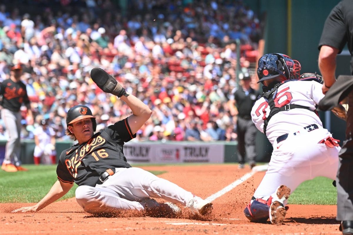 Jun 4, 2026; Boston, Massachusetts, USA; Baltimore Orioles third baseman Coby Mayo (16) slides home against Boston Red Sox catcher Carlos Narvaez (75) during the first inning at Fenway Park. Mandatory Credit: Eric Canha-Imagn Images