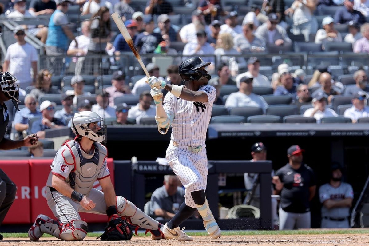 Jun 4, 2026; Bronx, New York, USA; New York Yankees second baseman Jazz Chisholm Jr. (13) follows through on an RBI sacrifice fly against the Cleveland Guardians during the fourth inning at Yankee Stadium. Mandatory Credit: Brad Penner-Imagn Images