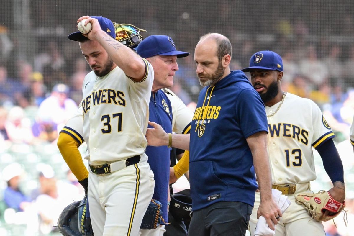 Jun 4, 2026; Milwaukee, Wisconsin, USA; Milwaukee Brewers pitcher DL Hall (37) leaves the game against the San Francisco Giants with athletic trainer Brad Epstein after an injury in the fifth inning at American Family Field. Mandatory Credit: Benny Sieu-Imagn Images