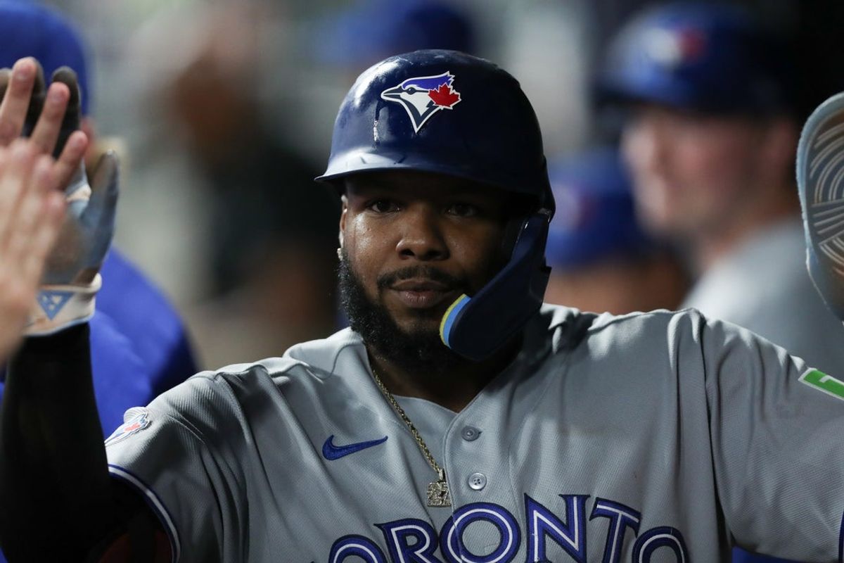 Jun 4, 2026; Cumberland, Georgia, USA; Toronto Blue Jays first baseman Vladimir Guerrero Jr. (27) celebrates with teammates in the dugout after scoring a run against the Atlanta Braves in the ninth inning at Truist Park. Mandatory Credit: Mady Mertens-Imagn Images