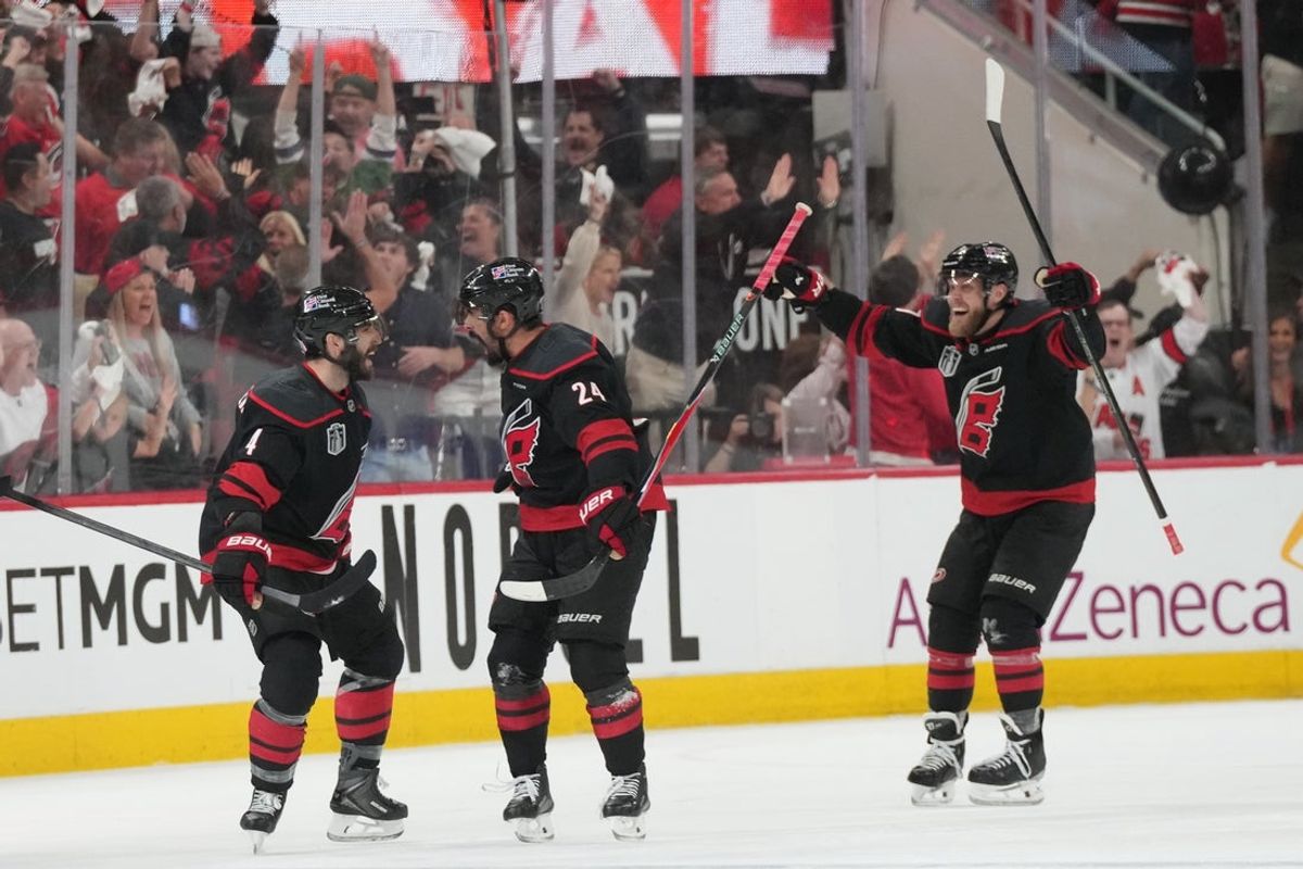 Jun 4, 2026; Raleigh, North Carolina, USA; Carolina Hurricanes right wing Seth Jarvis (24) celebrates scoring with defenseman Shayne Gostisbehere (4) in overtime against the Vegas Golden Knights in game two of the 2026 Stanley Cup Final at Lenovo Center. Mandatory Credit: James Guillory-Imagn Images