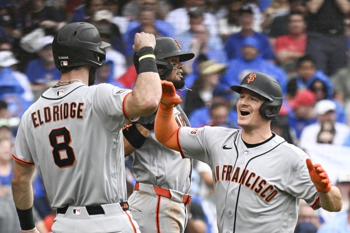 Jun 5, 2026; Chicago, Illinois, USA;  San Francisco Giants third baseman Matt Chapman (26), right, high fives San Francisco Giants second baseman Luis Arraez (1) and designated hitter Bryce Eldridge (8) after he hits a grand slam against the Chicago Cubs during the fourth inning at Wrigley Field. Mandatory Credit: Matt Marton-Imagn Images