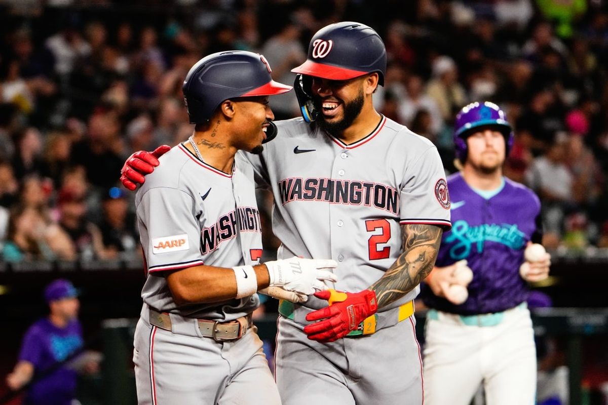 Jun 5, 2026; Phoenix, Arizona, USA; Washington Nationals first baseman Luis García Jr. (2) celebrates with  right fielder Dylan Crews (3) during the sixth inning at Chase Field against the Arizona Diamondbacks. Mandatory Credit: Arianna Grainey-Imagn Images