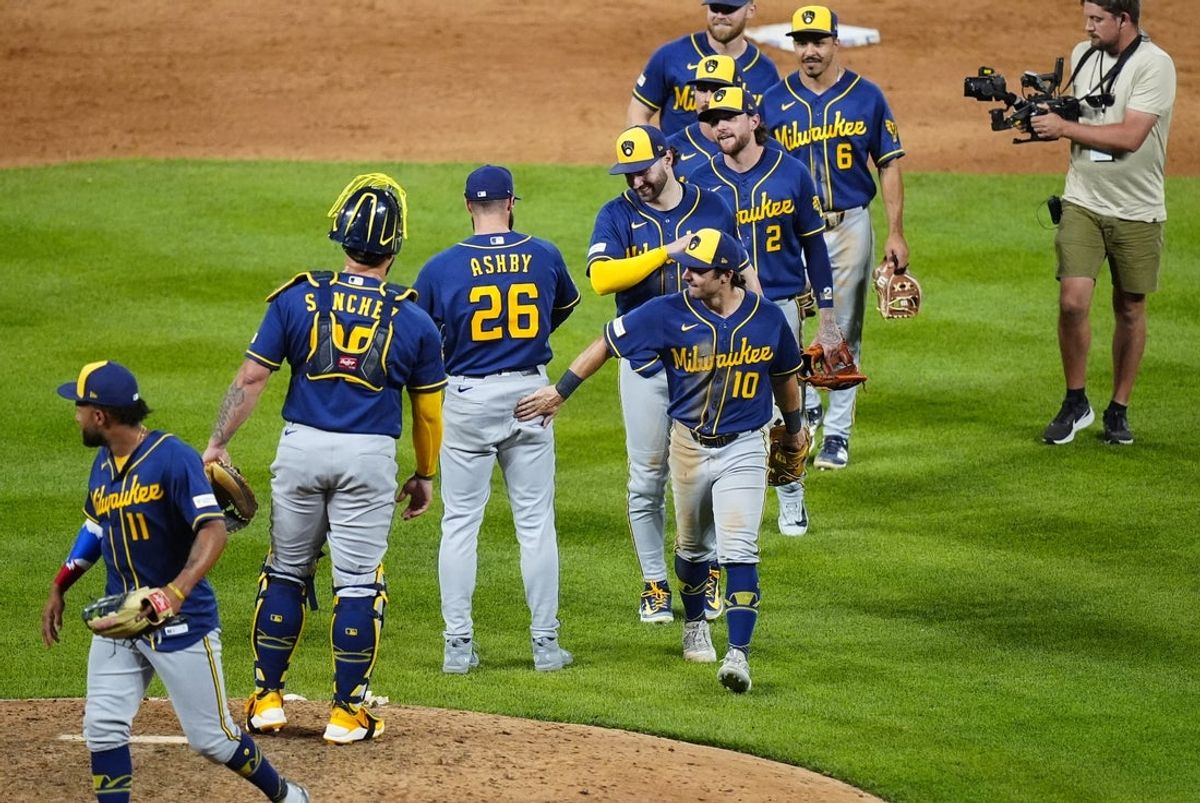 Jun 5, 2026; Denver, Colorado, USA; Members of the Milwaukee Brewers celebrate the tenth inning win against the Colorado Rockies at Coors Field. Mandatory Credit: Ron Chenoy-Imagn Images