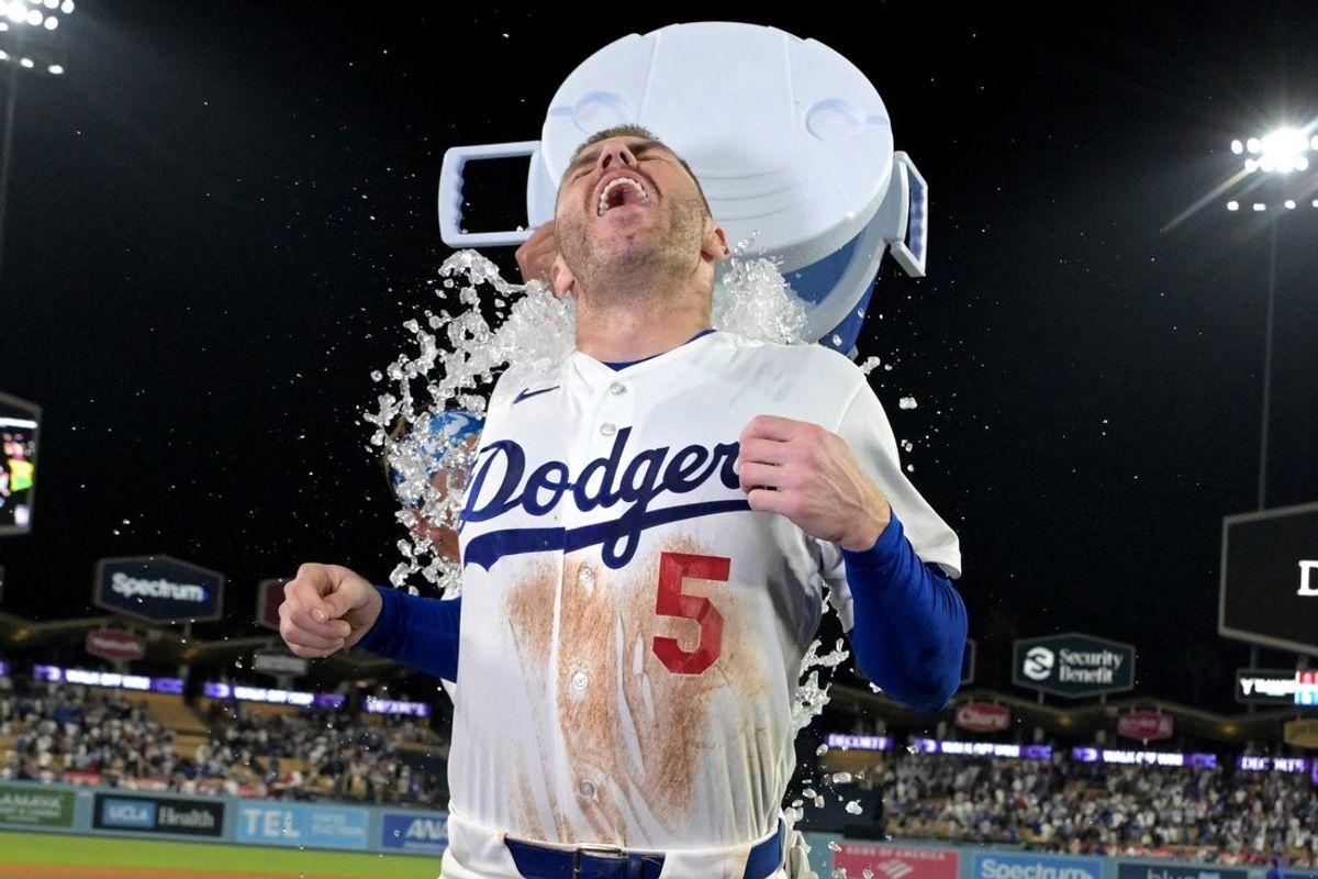 Jun 5, 2026; Los Angeles, California, USA;  Los Angeles Dodgers left fielder Alex Call (12) dumps a cooler of ice water on first baseman Freddie Freeman (5) after hitting a walk-off home run Los Angeles Angels in the ninth inning at Dodger Stadium. Mandatory Credit: Jayne Kamin-Oncea-Imagn Images