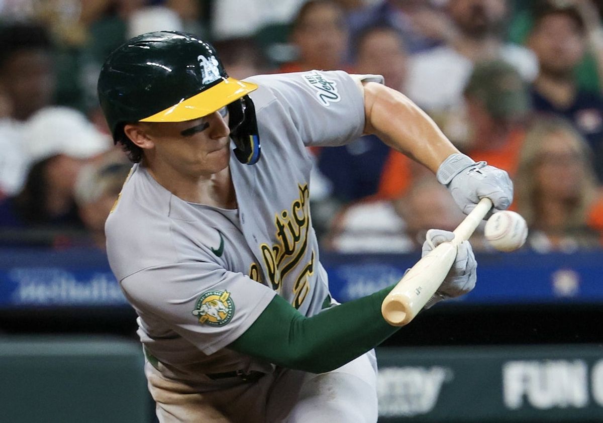 Jun 6, 2026; Houston, Texas, USA; Athletics third baseman Zack Gelof (20) bunts a single against the Houston Astros  in the second inning at Daikin Park. Mandatory Credit: Thomas Shea-Imagn Images
