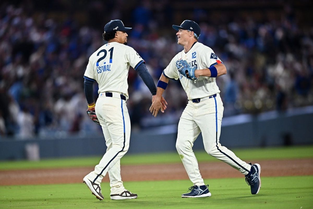 Jun 6, 2026; Los Angeles, California, USA; Los Angeles Dodgers infielder Santiago Espinal (21) celebrates with outfielder Alex Call (12) after defeating the Los Angeles Angels in the ninth inning at Dodger Stadium. Mandatory Credit: William Liang-Imagn Images