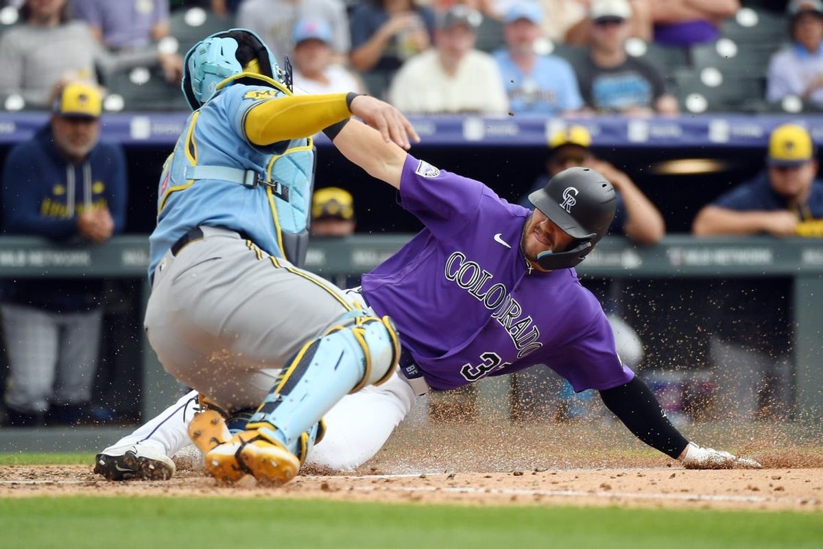 Jun 7, 2026; Denver, Colorado, USA; Colorado Rockies designated hitter Braxton Fulford (37) slides around the tag by Milwaukee Brewers catcher Gary Sanchez (99) in the fifth inning at Coors Field. Mandatory Credit: Christopher Hanewinckel-Imagn Images