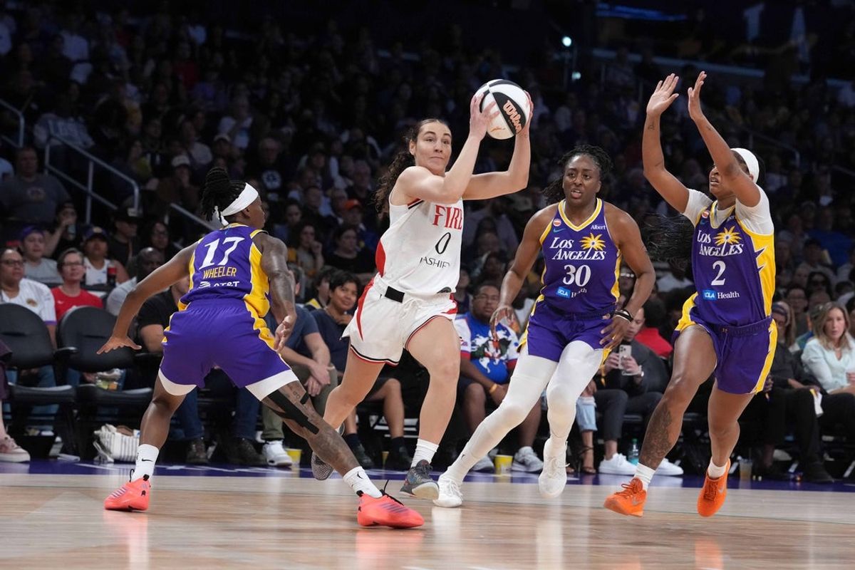 Jun 7, 2026; Los Angeles, California, USA; Portland Fire guard Carla Leite (0) drives to the basket against LA Sparks guard Erica Wheeler (17), forward Nneka Ogwumike (30) and guard Chance Gray (2)  in the first half at Crypto.com Arena. Mandatory Credit: Kirby Lee-Imagn Images