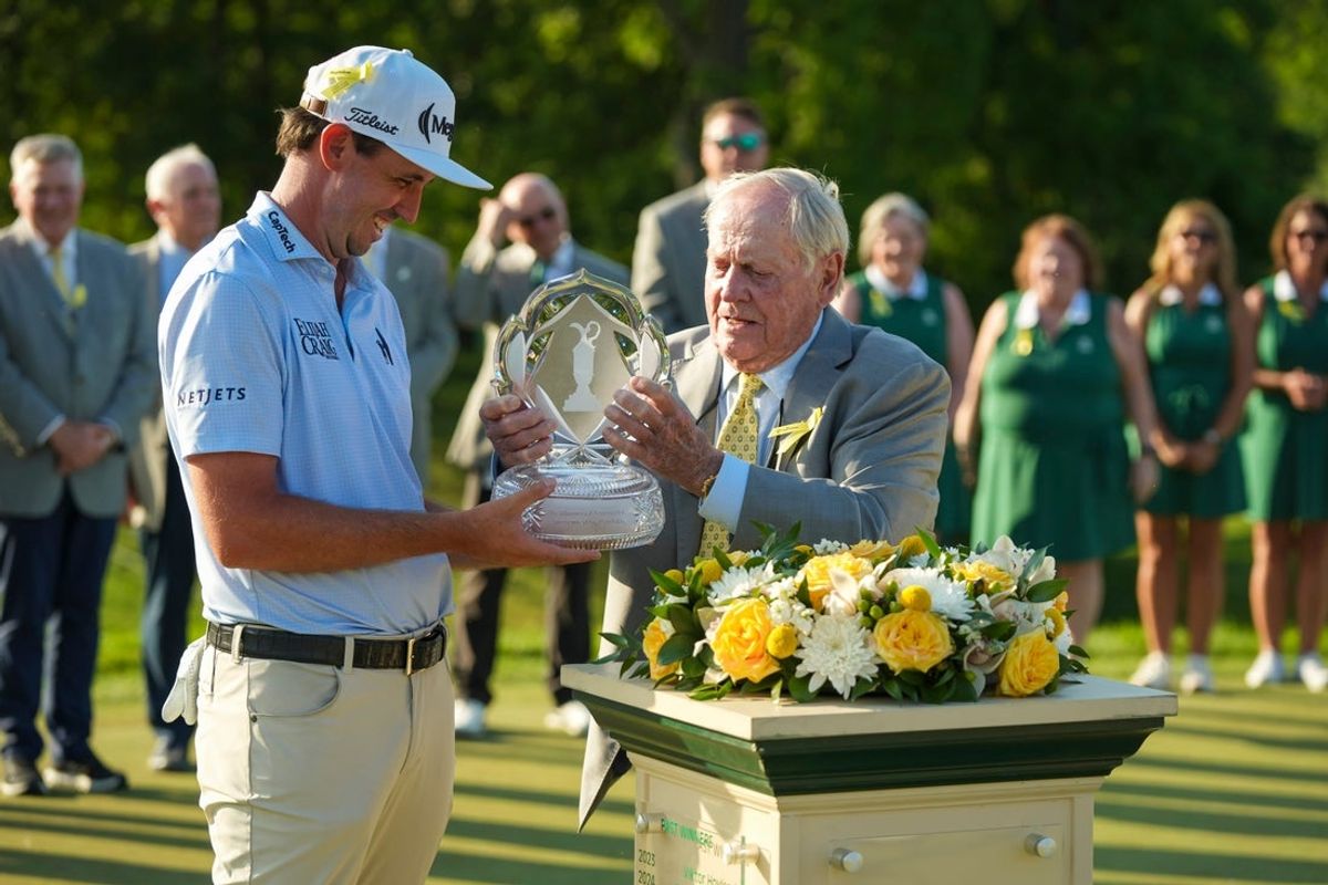 Jack Nicklaus hands the trophy to J.T. Poston following the final round of the Memorial Tournament at Muirfield Village Golf Club on June 7, 2026.
