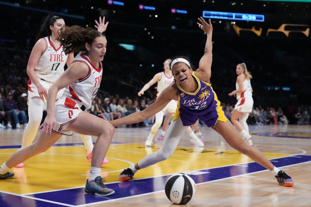 Jun 7, 2026; Los Angeles, California, USA; LA Sparks guard-forward Rae Burrell (12) is fouled by Portland Fire guard Carla Leite (0) in the second half at Crypto.com Arena. Mandatory Credit: Kirby Lee-Imagn Images