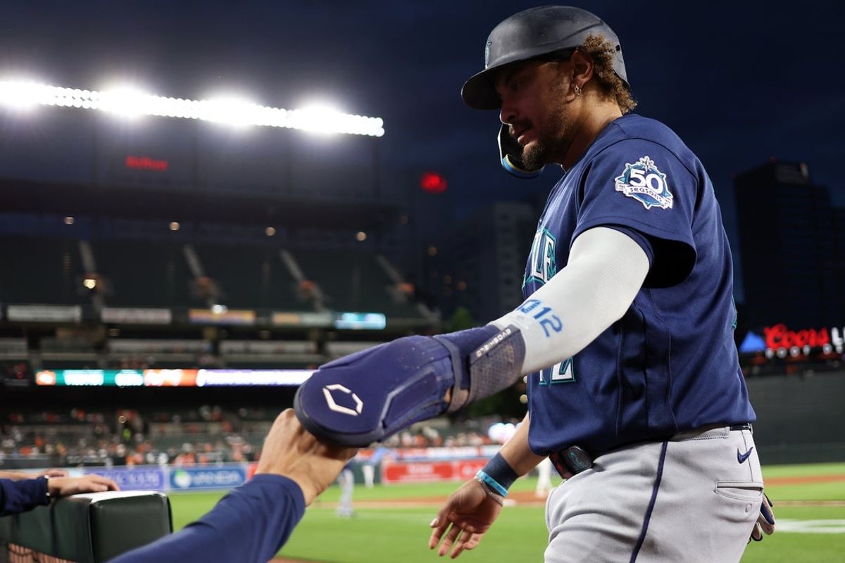 Jun 8, 2026; Baltimore, Maryland, USA; Seattle Mariners first baseman Josh Naylor (12) celebrates with his teammates after scoring a run during the eighth inning against the Baltimore Orioles at Oriole Park at Camden Yards. Mandatory Credit: Daniel Kucin Jr.-Imagn Images