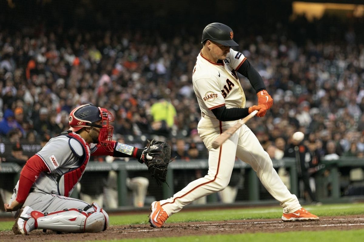 Jun 8, 2026; San Francisco, California, USA; San Francisco Giants third baseman Matt Chapman (26) connects for a single against the Washington Nationals during the fourth inning at Oracle Park. Nationals catcher is Keibert Ruiz. Mandatory Credit: D. Ross Cameron-Imagn Images
