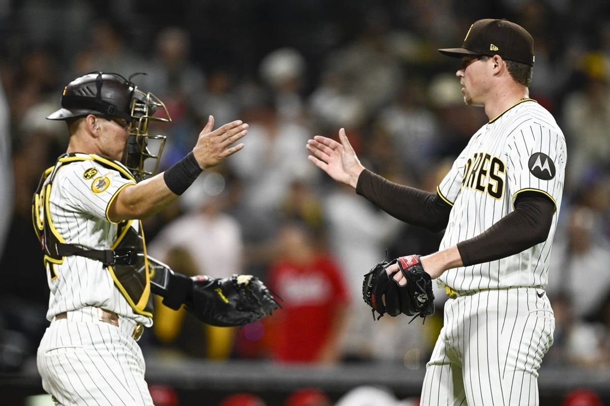 Jun 8, 2026; San Diego, California, USA; San Diego Padres pitcher Mason Miller (22) is congratulated by catcher Freddy Fermin (54) after the San Diego Padres beat the Cincinnati Reds at Petco Park. Mandatory Credit: Denis Poroy-Imagn Images