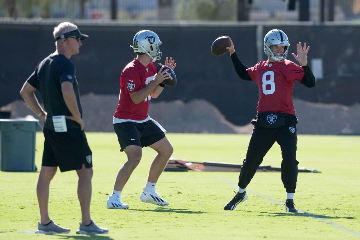 Jun 9, 2026; Henderson, NV, USA; Las Vegas Raiders quarterbacks Fernando Mendoza (15) and Kirk Cousins (8) throw the ball as assistant head coach Mike McCoy (left) watches during minicamp at Intermountain Health Performance Center. Mandatory Credit: Kirby Lee-Imagn Images