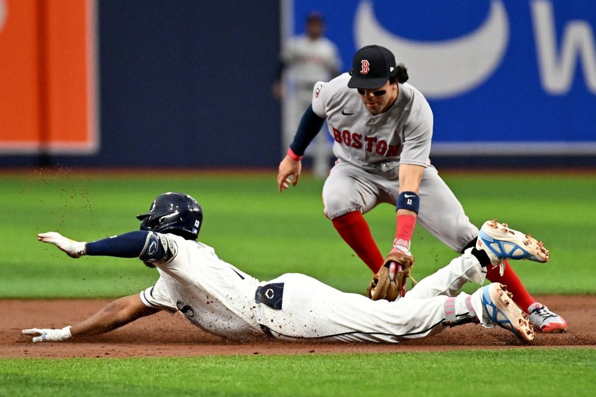 Jun 9, 2026; St. Petersburg, Florida, USA; Tampa Bay Rays third baseman Junior Caminero (13) avoids the tag of Boston Red Sox shortstop Marcelo Mayer (11) in the first inning at Tropicana Field. Mandatory Credit: Jonathan Dyer-Imagn Images