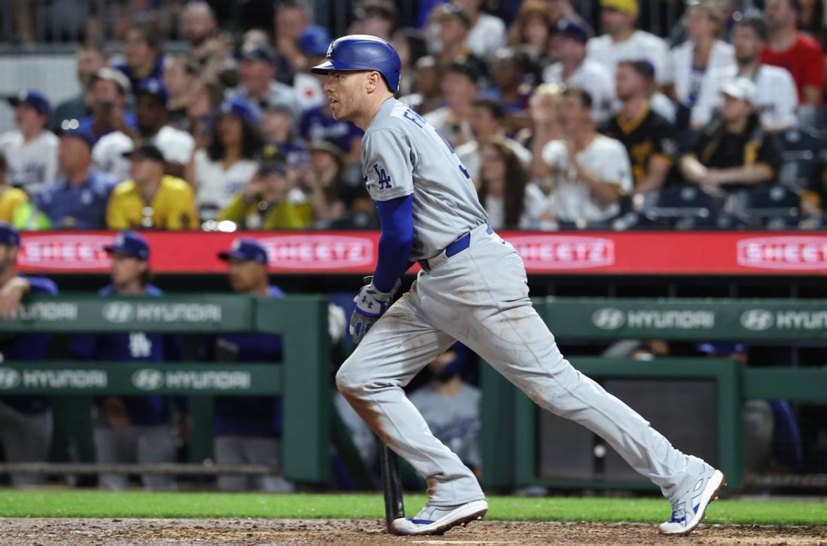 Jun 9, 2026; Pittsburgh, Pennsylvania, USA;  Los Angeles Dodgers first baseman Freddie Freeman (5) hits an RBI  single to record his twenty-five hundred MLB career hit against the Pittsburgh Pirates during the seventh inning at PNC Park. Mandatory Credit: Charles LeClaire-Imagn Images