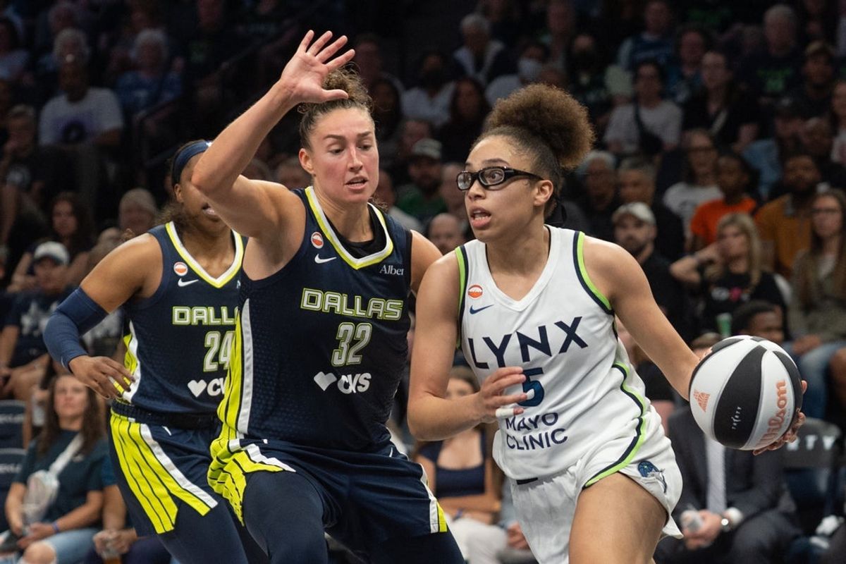 Jun 9, 2026; Minneapolis, Minnesota, USA; Minnesota Lynx guard Olivia Miles (5) drives to the basket past Dallas Wings forward Jessica Shepard (32) in the fourth quarter at Target Center. Mandatory Credit: Matt Blewett-Imagn Images
