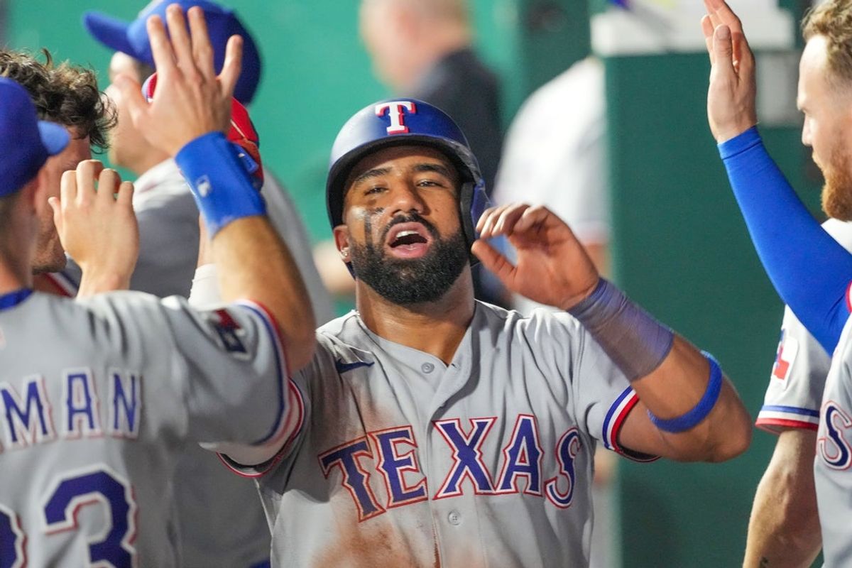 Jun 10, 2026; Kansas City, Missouri, USA; Texas Rangers first baseman Ezequiel Duran (20) celebrates in the dugout after scoring against the Kansas City Royals during the tenth inning at Kauffman Stadium. Mandatory Credit: Denny Medley-Imagn Images