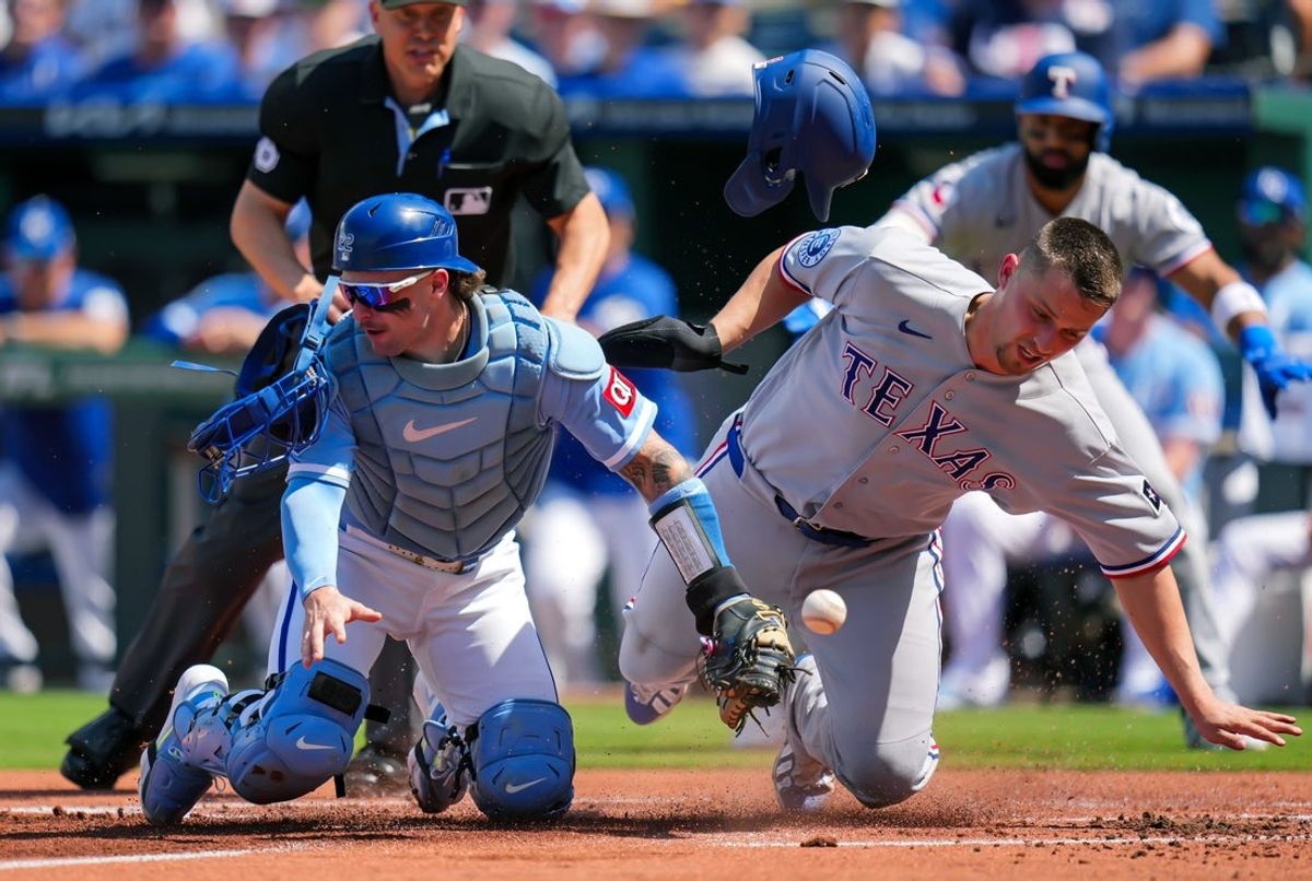 Jun 11, 2026; Kansas City, Missouri, USA; Texas Rangers shortstop Corey Seager (5) collides with Kansas City Royals catcher Carter Jensen (22) as he scores a run during the first inning at Kauffman Stadium. Mandatory Credit: Jay Biggerstaff-Imagn Images