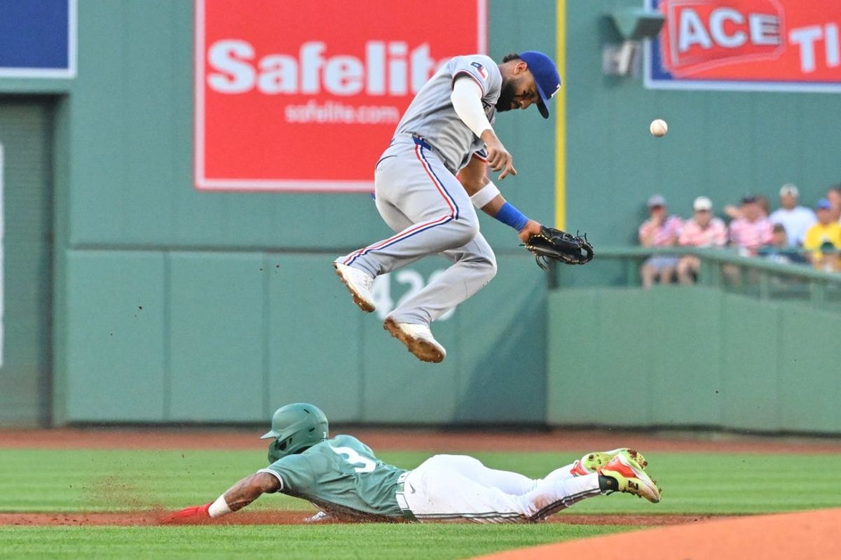 Jun 12, 2026; Boston, Massachusetts, USA; Boston Red Sox center fielder Ceddanne Rafaela (3) dives under Texas Rangers shortstop Ezequiel Duran (20) as he steals second base during the first inning at Fenway Park. Mandatory Credit: Eric Canha-Imagn Images