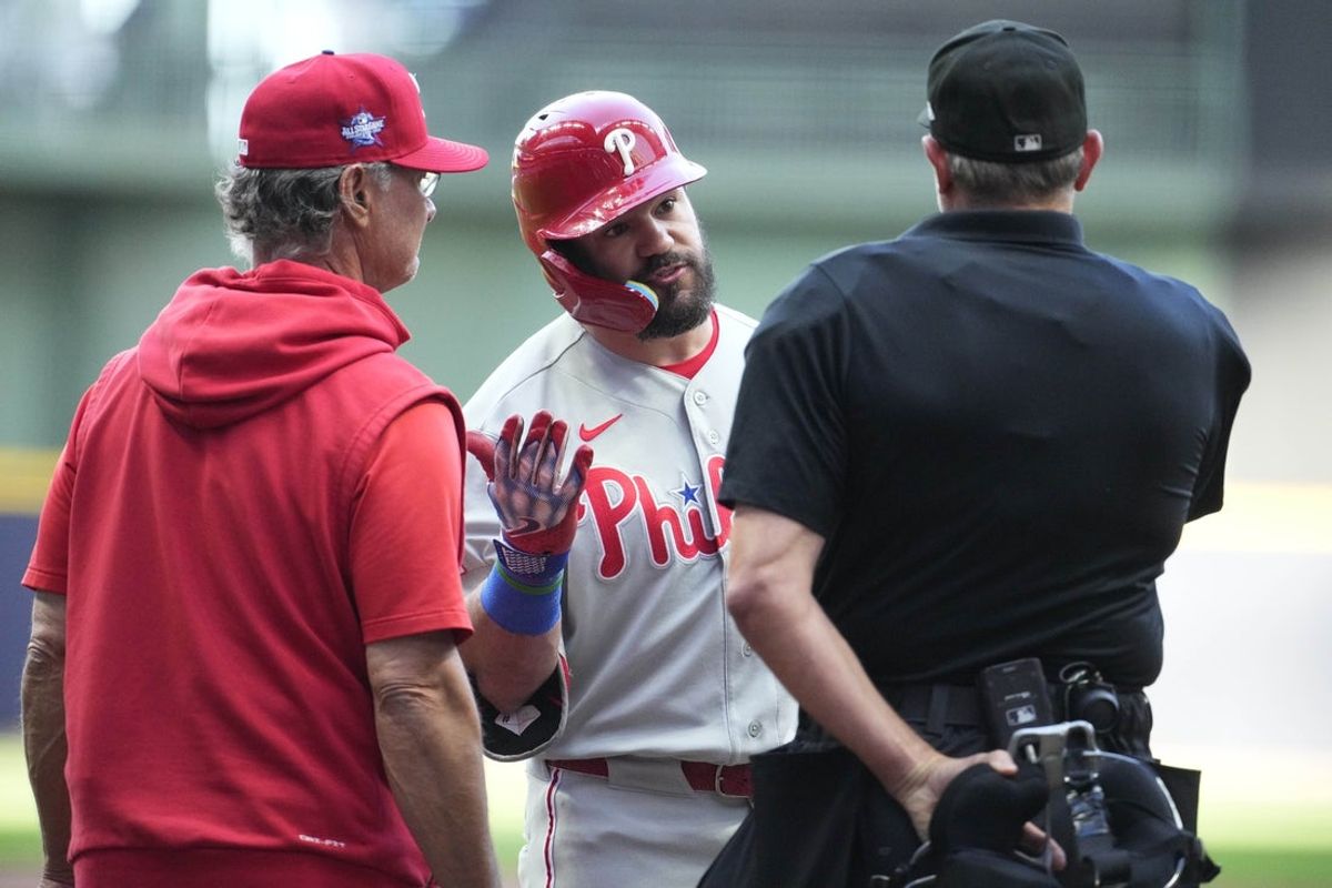 Jun 12, 2026; Milwaukee, Wisconsin, USA; Philadelphia Phillies designated hitter Kyle Schwarber (12) argues a call on a third strike with umpire Chad Fairchild (4) in the first inning at American Family Field. Philadelphia Phillies bench coach Don Mattingly (8) is at the left. Mandatory Credit: Michael McLoone-Imagn Images