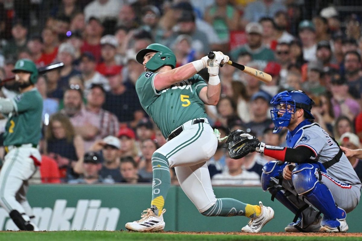 Jun 12, 2026; Boston, Massachusetts, USA; Boston Red Sox third baseman Caleb Durbin (5) hits a sacrifice fly ball to bring first baseman Willson Contreras (40) (not pictured) in for a run against the Texas Rangers during the fifth inning at Fenway Park. Mandatory Credit: Eric Canha-Imagn Images