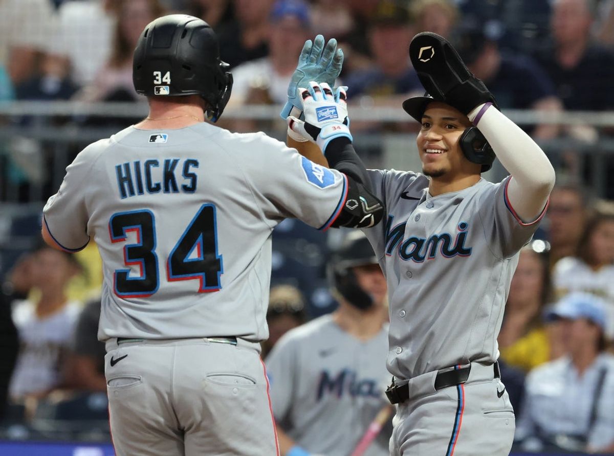 Jun 12, 2026; Pittsburgh, Pennsylvania, USA; Miami Marlins third baseman Javier Sanoja (right) greets designated hitter Liam Hicks (34) crossing home plate on a two run home run against the Pittsburgh Pirates during the eighth inning at PNC Park. Mandatory Credit: Charles LeClaire-Imagn Images