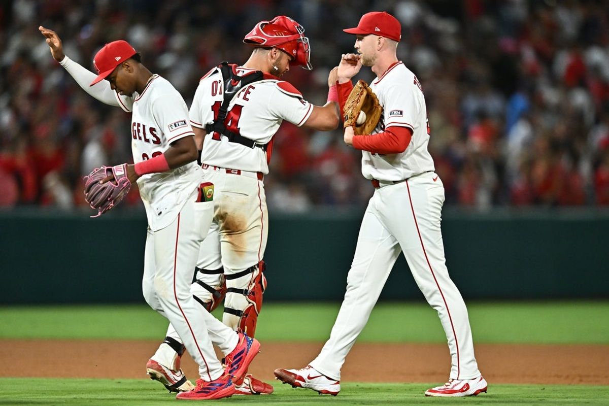 Jun 12, 2026; Anaheim, California, USA; Los Angeles Angels pitcher Ryan Zeferjahn (56) is greeted by catcher Logan O'Hoppe (14) after defeating the Tampa Bay Rays at Angel Stadium. Mandatory Credit: William Liang-Imagn Images
