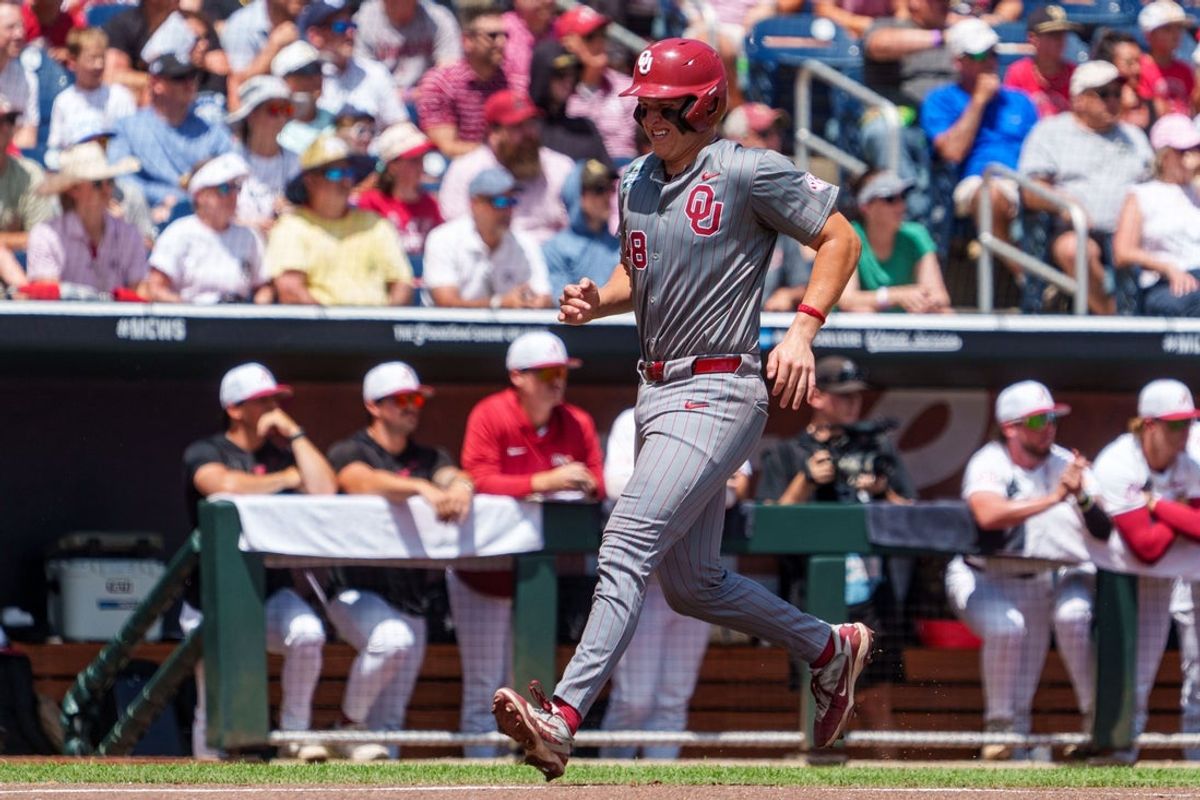Jun 13, 2026; Omaha, NE, USA; Oklahoma Sooners catcher Deiten Lachance (48) scores a run on two RBI double by designated hitter Trey Gambill (not pictured) during the first inning against the Alabama Crimson Tide at Charles Schwab Field. Mandatory Credit: Dylan Widger-Imagn Images