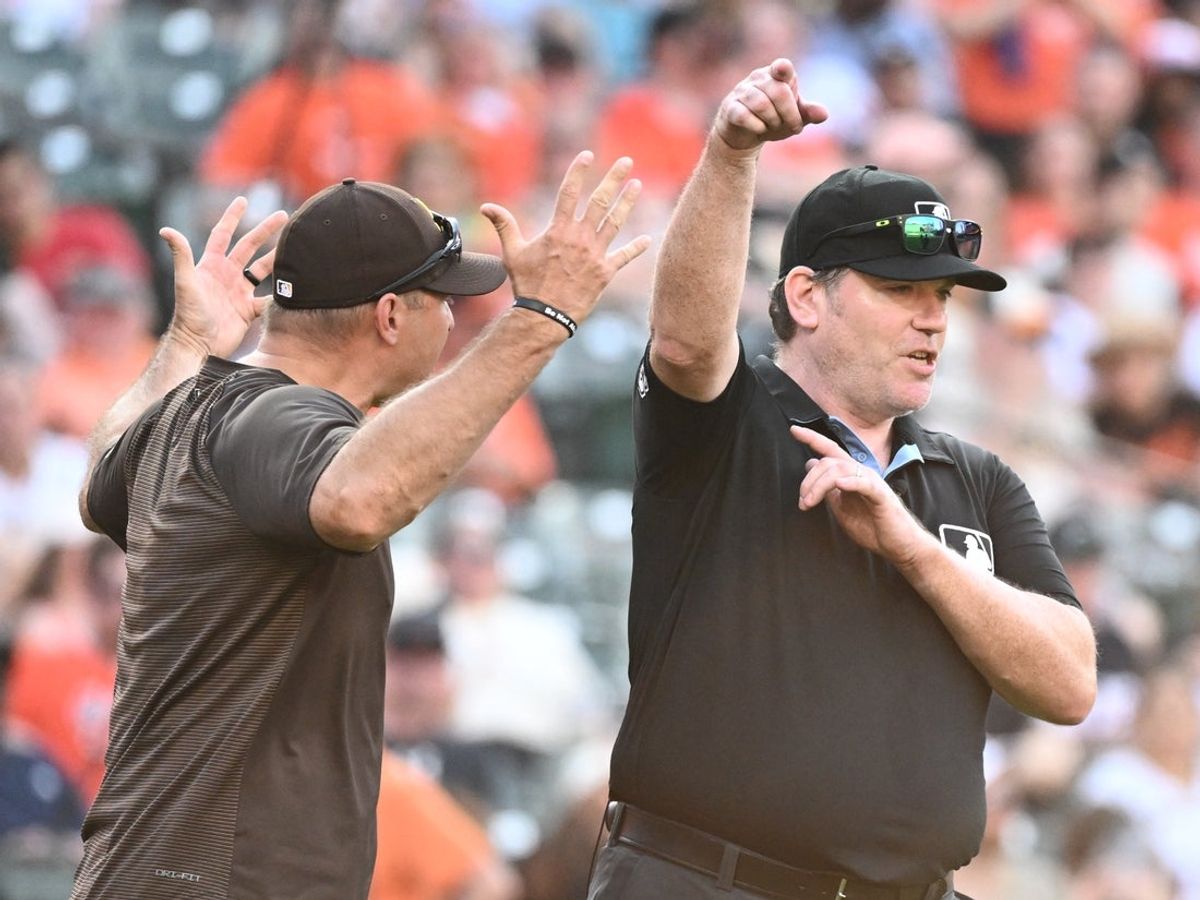 Jun 13, 2026; Baltimore, Maryland, USA;  Umpire Chris Conroy (98) ejects San Diego Padres manager Craig Stammen (14) from the game during the ninth inning against the Baltimore Orioles at Oriole Park at Camden Yards. Mandatory Credit: James A. Pittman-Imagn Images