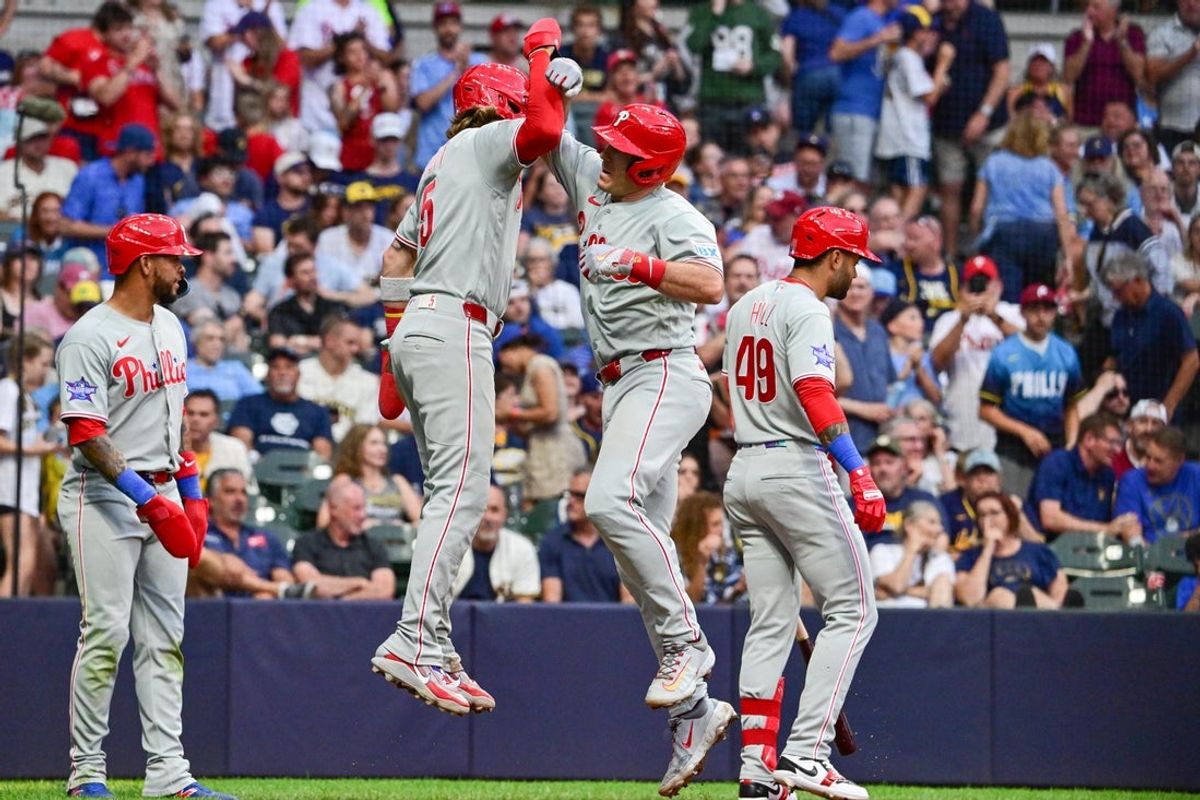 Jun 13, 2026; Milwaukee, Wisconsin, USA; Philadelphia Phillies catcher J.T. Realmuto (10) celebrates with second baseman Bryson Stott (5) after hitting a three-run home run in the sixth inning against the Milwaukee Brewers at American Family Field. Mandatory Credit: Benny Sieu-Imagn Images