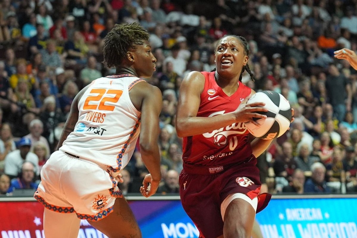 Jun 13, 2026; Uncasville, Connecticut, USA; Indiana Fever guard Kelsey Mitchell (0) drives the ball against Connecticut Sun guard Saniya Rivers (22) during the second half at Mohegan Sun Arena. Mandatory Credit: Gregory Fisher-Imagn Images