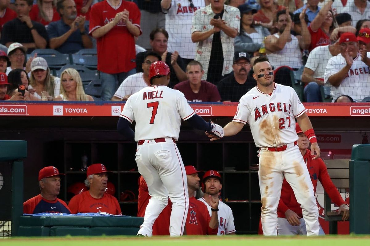 Jun 13, 2026; Anaheim, California, USA;  Los Angeles Angels right fielder Jo Adell (7)  is greeted by center fielder Mike Trout (27) after scoring a run during the fourth inning at Angel Stadium. Mandatory Credit: Kiyoshi Mio-Imagn Images