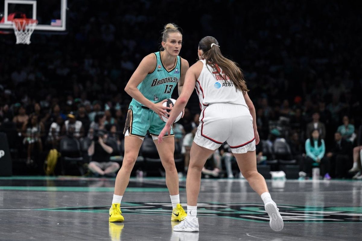 Jun 14, 2026; Brooklyn, New York, USA; New York Liberty forward Leonie Fiebich (13) sets the play while defended by Washington Mystics forward Angela Dugalic (32) during the first half at Barclays Center. Mandatory Credit: John Jones-Imagn Images