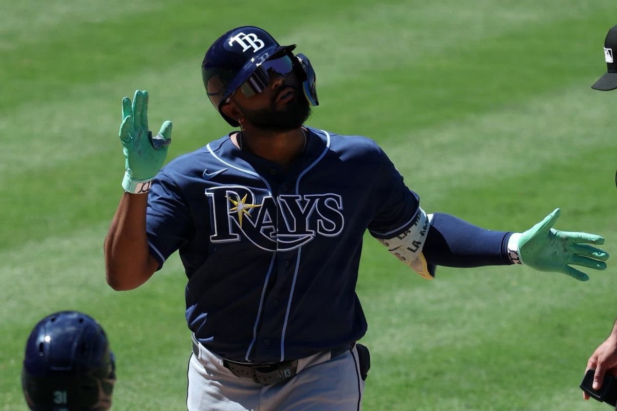 Jun 14, 2026; Anaheim, California, USA;  Tampa Bay Rays third baseman Junior Caminero (13) celebrates as he scores a run after hitting a two-run home run during the eighth inning against the Los Angeles Angels at Angel Stadium. Mandatory Credit: Kiyoshi Mio-Imagn Images