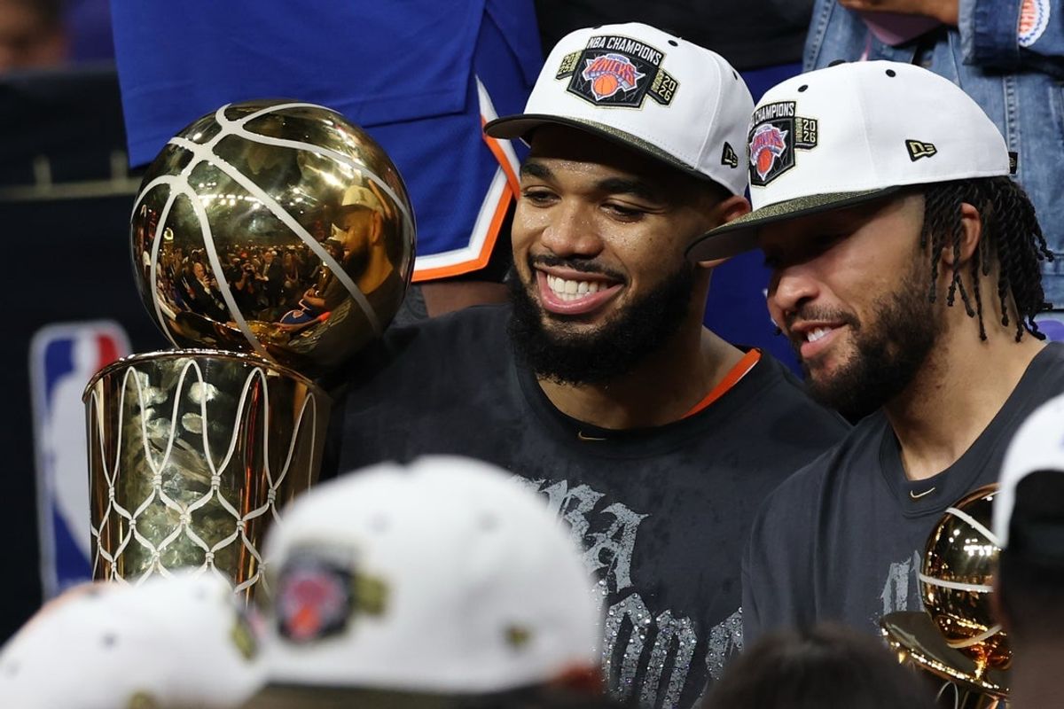 Jun 13, 2026; San Antonio, Texas, USA; New York Knicks center Karl-Anthony Towns (L) holds the Larry O'Brien championship trophy as Knicks guard Jalen Brunson (R) holds the Finals MVP trophy after game five of the 2026 NBA Finals against the San Antonio Spurs at Frost Bank Center. Mandatory Credit: Geoff Burke-Imagn Images