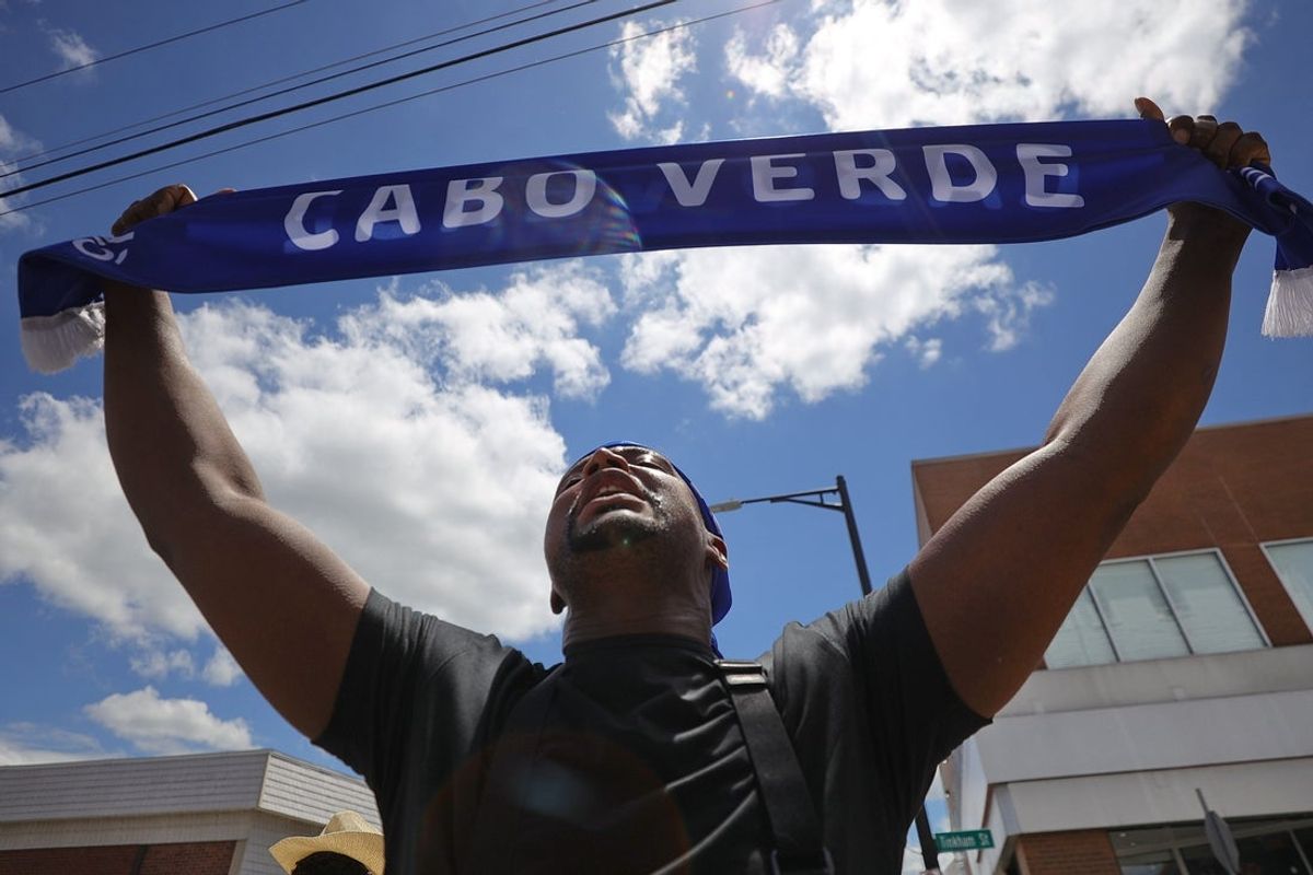 Helder Afonso is in a state of disbelief after Cape Verde tied against Spain in the World Cup, by waving a Cape Verdean scarf after a watch party held at Praia Vibes Bar & Grill in New Bedford.