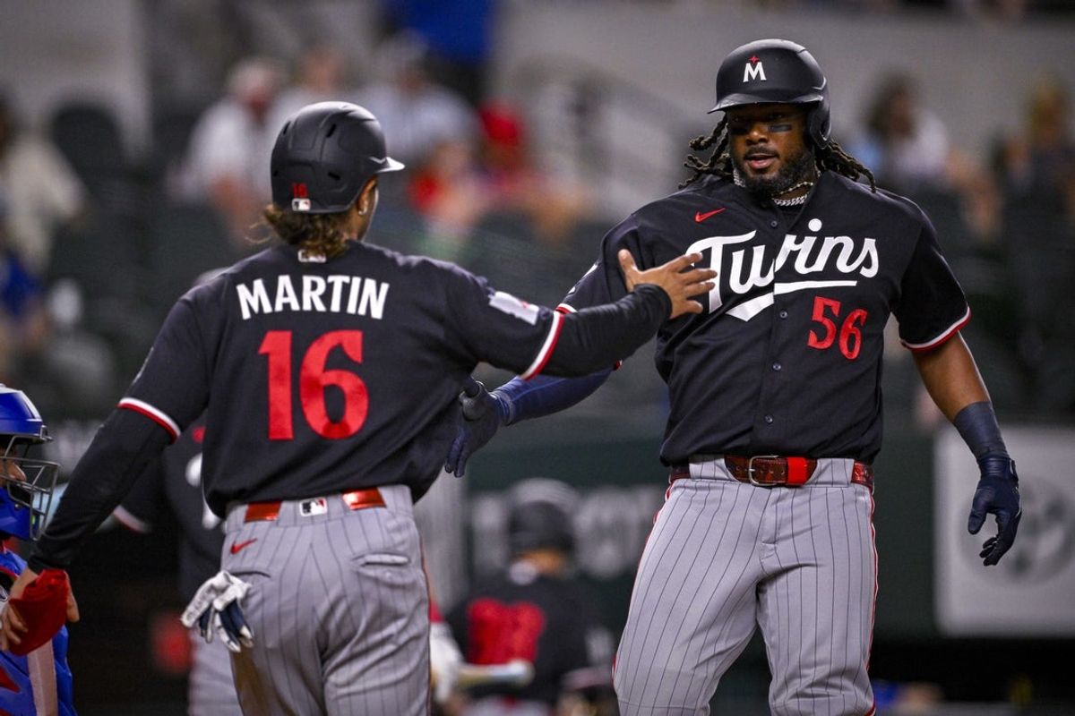 Jun 15, 2026; Arlington, Texas, USA; Minnesota Twins right fielder Austin Martin (16) and designated hitter Josh Bell (56) celebrate after Bell hits a three run home run against the Texas Rangers during the first inning at Globe Life Field. Mandatory Credit: Jerome Miron-Imagn Images