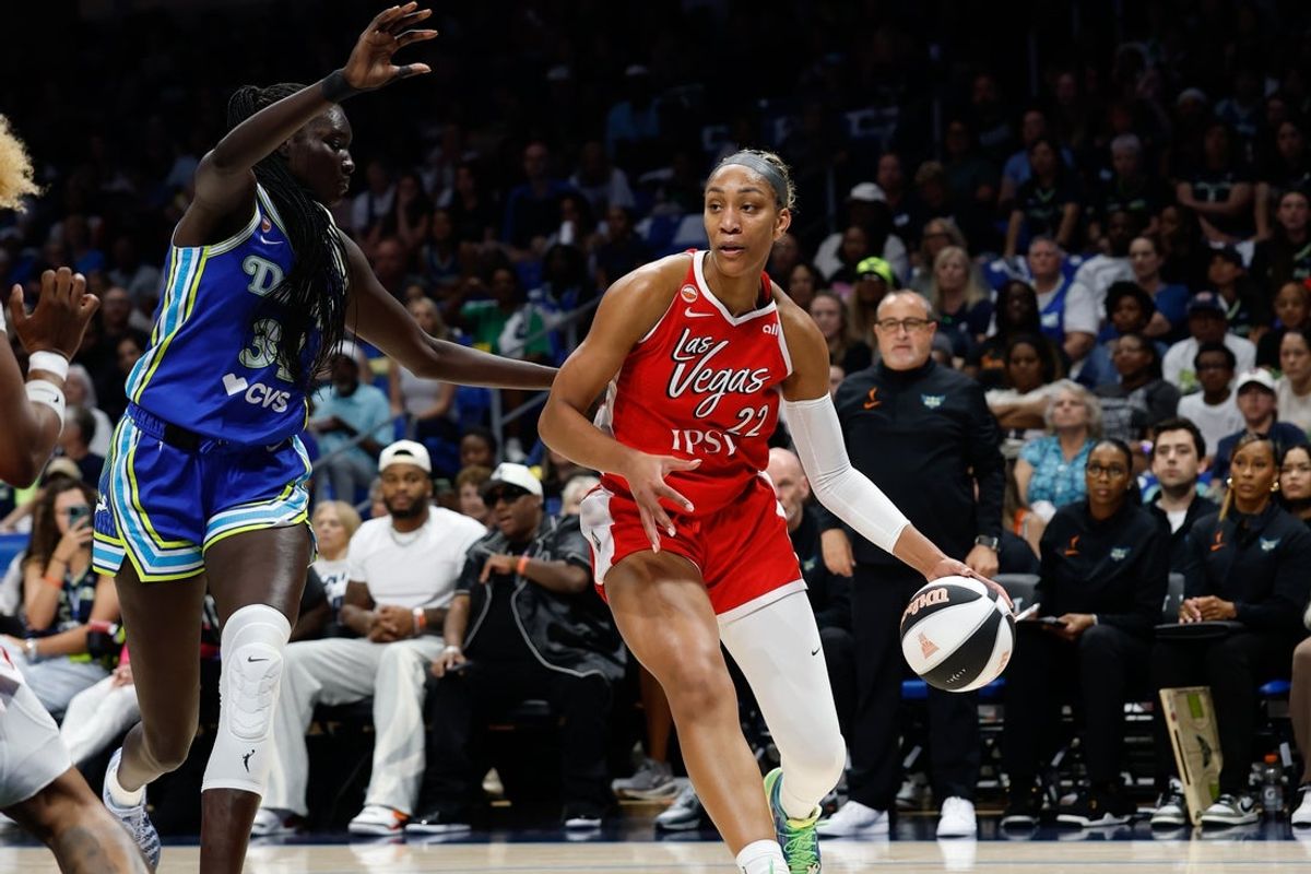 Jun 15, 2026; Arlington, Texas, USA; Las Vegas Aces center A'ja Wilson (22) controls the ball as Dallas Wings forward Awak Kuier (34) defends during the first half at College Park Center. Mandatory Credit: Chris Jones-Imagn Images