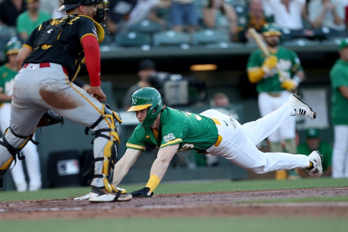Jun 15, 2026; West Sacramento, California, USA; Athletics center fielder Henry Bolte (33) slides safely into home on a hit by second baseman Jeff McNeil (not pictured) against the Pittsburgh Pirates during the second inning at Sutter Health Park. Mandatory Credit: Dennis Lee-Imagn Images