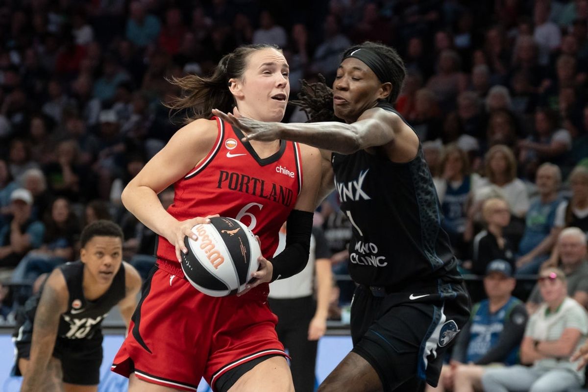 Jun 15, 2026; Minneapolis, Minnesota, USA; Portland Fire forward Bridget Carleton (6) drives to the basket past Minnesota Lynx forward Natasha Howard (1) in the second half at Target Center. Mandatory Credit: Jesse Johnson-Imagn Images