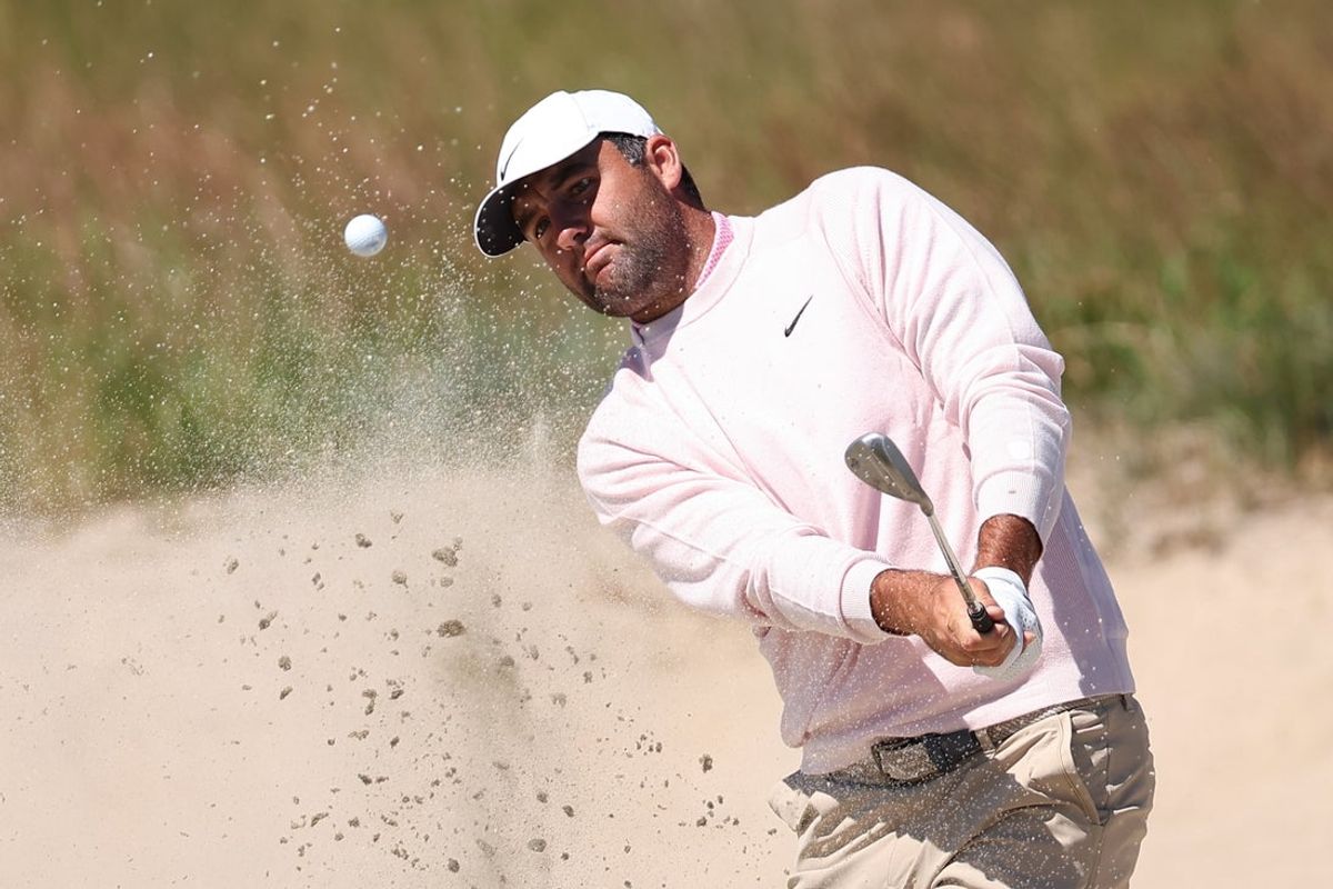 Jun 16, 2026; Southampton, New York, USA; Scottie Scheffler plays a bunker shot on the second hole during a practice round for the U.S. Open golf tournament. Mandatory Credit: Bill Streicher-Imagn Images