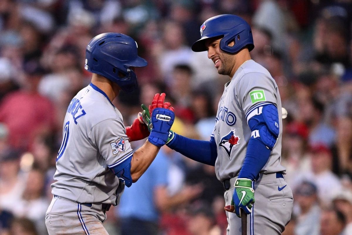 Jun 16, 2026; Boston, Massachusetts, USA; Toronto Blue Jays shortstop Andrés Giménez (0) celebrates with designated hitter George Springer (4) after hitting a solo home run against the Boston Red Sox during the fifth inning at Fenway Park. Mandatory Credit: Brian Fluharty-Imagn Images